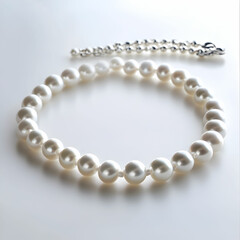 Obraz premium A pearl necklace gracefully displayed on a clean white background