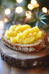 Slice of Rustic Bread Topped with Bright Yellow Lemon Curd on Wooden Board with Bokeh Lights