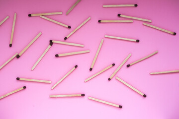 The matches are scattered on a pink background, a view of the top. International Mat Day. The matches are scattered on a pink background.
