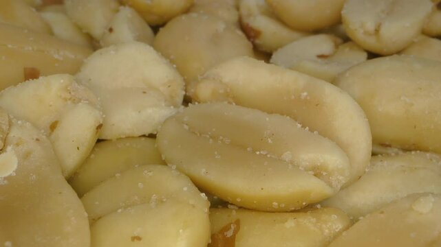 Peanuts, shelled, roasted and salted. Probe lens macro. Extreme closeup.