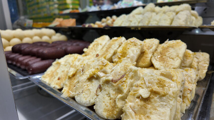 Popular Indian sweets displayed in a vibrant dessert shop