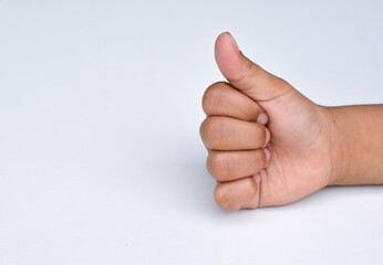 Child hand gesture giving thumbs up, like.Isolated on white background. Design elements. Concept of success or victory