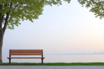 Obraz premium Serenity by the lake at dawn with a wooden bench under a lush green tree