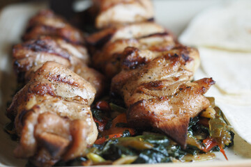 Grilled chicken skewers with colorful vegetables on a plate