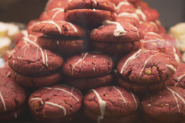 Freshly baked red velvet cookies stacked in display case