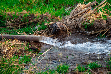 pump pipe water flow equipment agriculture, pump pipe water flow equipment agriculture, Water from a well filled a pond for irrigation,Irrigation water from the source