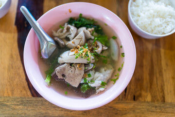 Thai style boiled clear soup with pork entrails pork blood cubes and liver in bowl served with rice. Healthy and rich in iron and protein