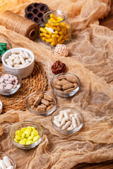 Many vitamins, minerals, food supplements, pills in a beautiful rustic composition, top view. Dietary supplements in small plates from above. Vitamins to improve health and strengthen immunity. 