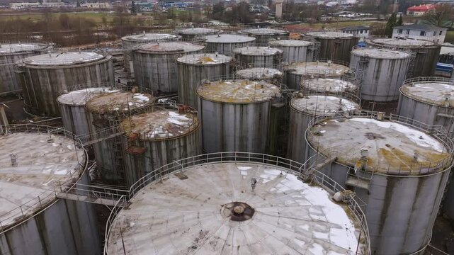 Aerial drone footage showcasing vast fuel storage tanks in a refinery, Latvia