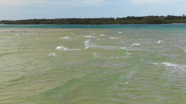 Drone flying over Bellinger River waters, Urunga in Australia. Aerial at low altitude