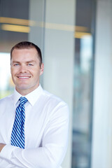 Fototapeta premium Portrait, corporate and man with confidence in office for accounting, investment deal and experience. Male person, arms crossed and financial growth with pride, consultant and business opportunity