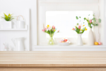 Empty wooden table on blurred window sill with easter decoration background