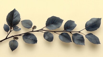 A delicate branch of dark blue leaves arranged artistically on a soft yellow background