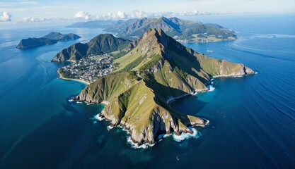 Aerial view of a green island surrounded by deep blue waters, with a city nestled along its coastline and mountains rising dramatically in the background