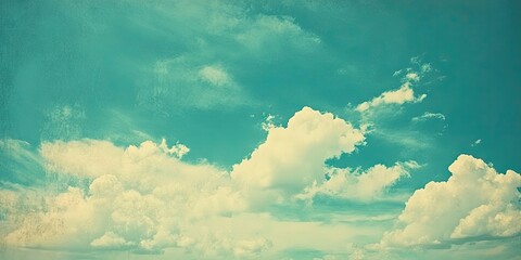 Vintage-inspired sky with soft white clouds against an aqua backdrop featuring ample copy space, ideal for creative projects and text overlays.