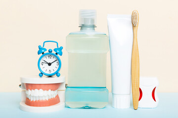 Mouthwash and other oral hygiene products on colored table top view with copy space. Flat lay. Dental hygiene. Oral care kit. Dentist concept