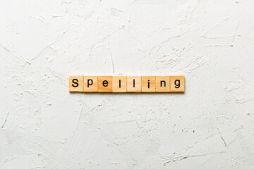 spelling word written on wood block. spelling text on cement table for your desing, concept