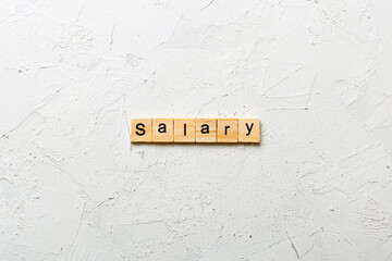 salary word written on wood block. salary text on table, concept