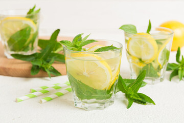 Mojito cocktail. Refreshing mojito cocktail with lime, lemon and mint in a tall glass with a stick