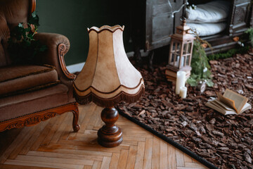 Cozy living room corner with vintage lamp on wooden floor and rustic decor