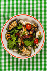 Fresh grilled vegetable salad with spinach and cherry tomatoes