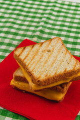 Delicious grilled cheese sandwich served on a red napkin for lunch or brunch