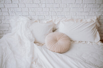 Soft bedding arrangement with decorative pillows in a cozy bedroom setting