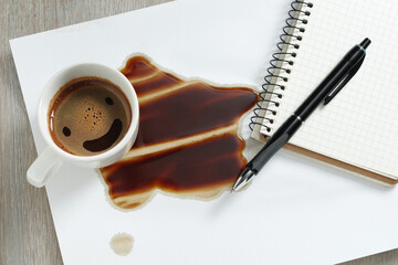 Spilled coffee and a blank sheet of notepad