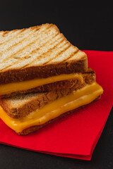 Perfectly grilled cheese sandwich served on a bright red napkin