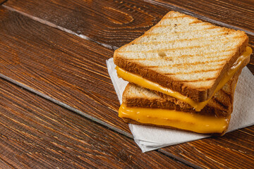 Delicious grilled cheese sandwich stacked on a wooden table for lunch