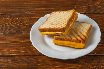 Delicious grilled cheese sandwich served on a white plate for brunch