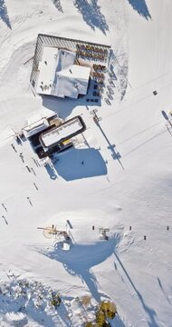 Aerial drone view of a ski resort in Col dei Baldi, Alleghe, in the Dolomites, Italy in daylight. Vertical