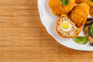 Savory dish on a white plate with golden crusts and tasty ingredients