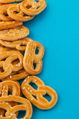 Freshly baked pretzels on a vibrant blue background