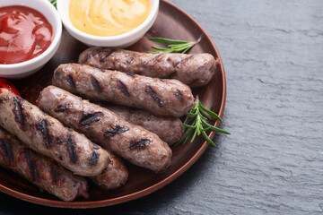 Grilled beef sausages with rosemary sauce and tomatoes photography . Top view
