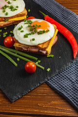Delicious breakfast sandwich topped with eggs, vegetables, and spices