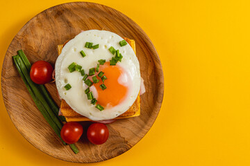 Delicious breakfast with fried eggs on toast with fresh vegetables