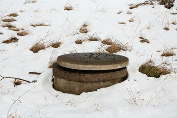 Water system concrete well with cover in winter