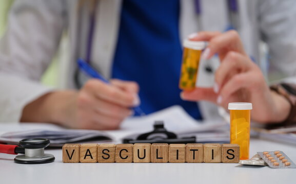 A dedicated healthcare professional meticulously prepares vasculitis medications while carefully taking notes
