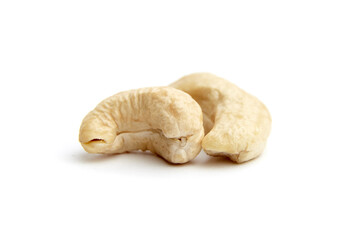 Close-up view of two raw cashew nuts arranged on a white surface, showcasing their natural texture and curved shape. Perfect for healthy eating themes