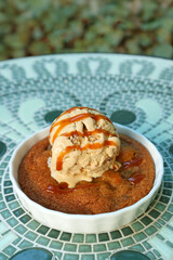 A Plate of Warm Skillet Cookie Topped with Ice Cream and Salted Caramel Sauce