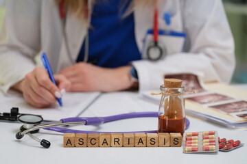 A dedicated healthcare professional is documenting key details about ascariasis treatment in a clinical setting