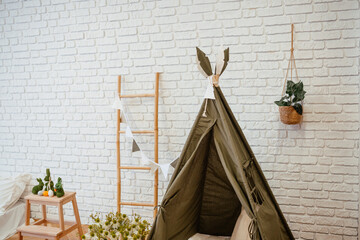 Cozy indoor play area with a teepee and decorative elements