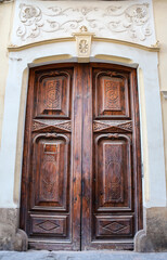 Building entrance with carved stone details and old wooden door