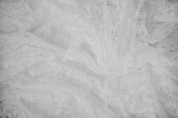 White lace fabric draped elegantly on a flat surface indoors