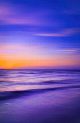 Fototapeta premium Abstract nature unfolds with blurred motion of blue and purple waters meeting the horizon.