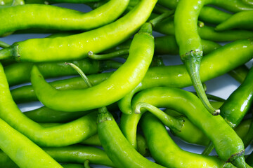 Chilies texture background. Food texture background of green chillies. Spicy, bright breen, vegetables, abstract, fresh, Asian ingredients, cooking concepts for wallpaper, cover, green food background