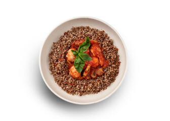 A vibrant and appetizing plate of buckwheat groats topped with meatballs in a rich tomato sauce.