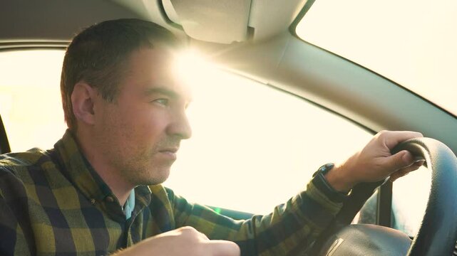 driver goes blind from the bright sun while driving the car. poor visibility in bright daylight. The driver puts on sunglasses.