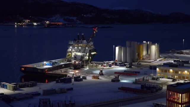 Mobile crane unloads containers from the offshore supply at Vestbase in Kristiansund, Norway